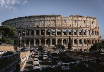 The Colosseum stands majestically amidst bustling Rome, an iconic remnant of ancient architecture.