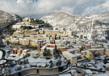 Picturesque scenery of small remote town located on hillside and covered with snow on sunny winter day