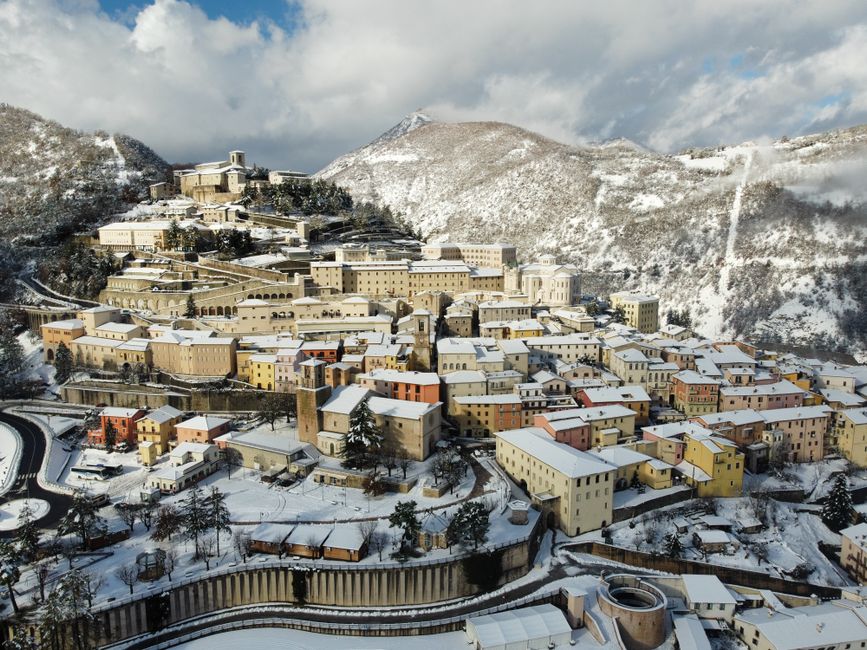 Picturesque scenery of small remote town located on hillside and covered with snow on sunny winter day