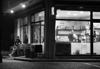 Elegant grayscale image of a coffee bar at night in Castel d'Azzano, Italy.