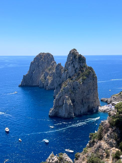 Breathtaking view of Capri's Faraglioni rocks towering above the azure sea, perfect for travel inspiration.