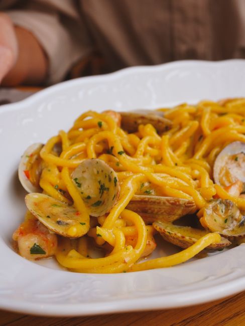 Savor a dish of spaghetti with clams, perfect for seafood lovers.