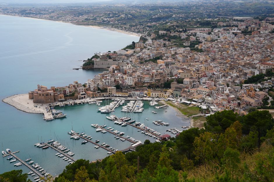 Stunning aerial shot of Castellammare del Golfo's marina and town in Sicily, Italy.