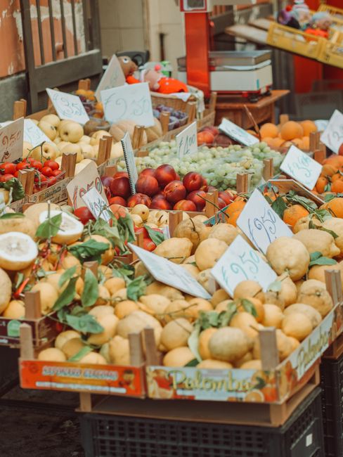 Colorful display of fresh fruits at a market in Sorrento, Italy, featuring citrus and other seasonal produce.