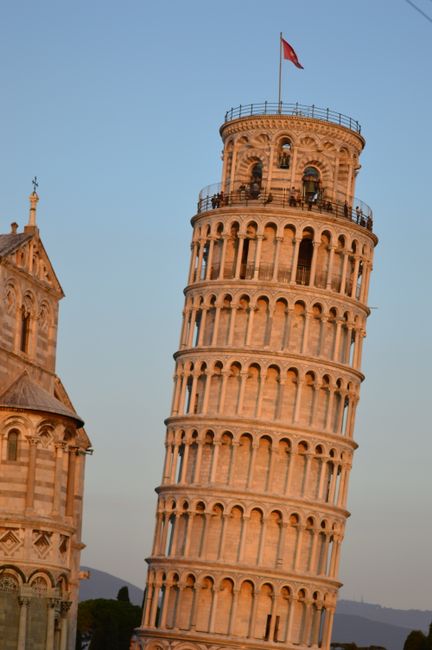 Captivating view of the Leaning Tower of Pisa during sunset in Italy.