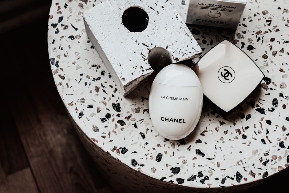 Minimalist display of Chanel's La Crème Main on terrazzo surface.