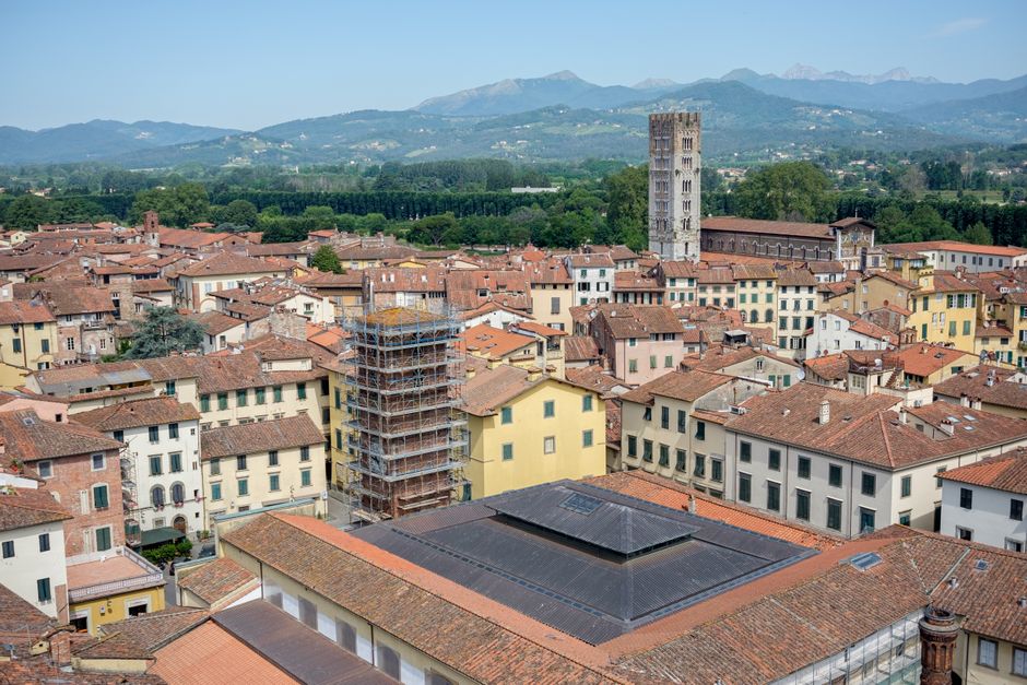 Panoramic aerial view of Lucca, Tuscany showcasing historic architecture and scenic landscapes.