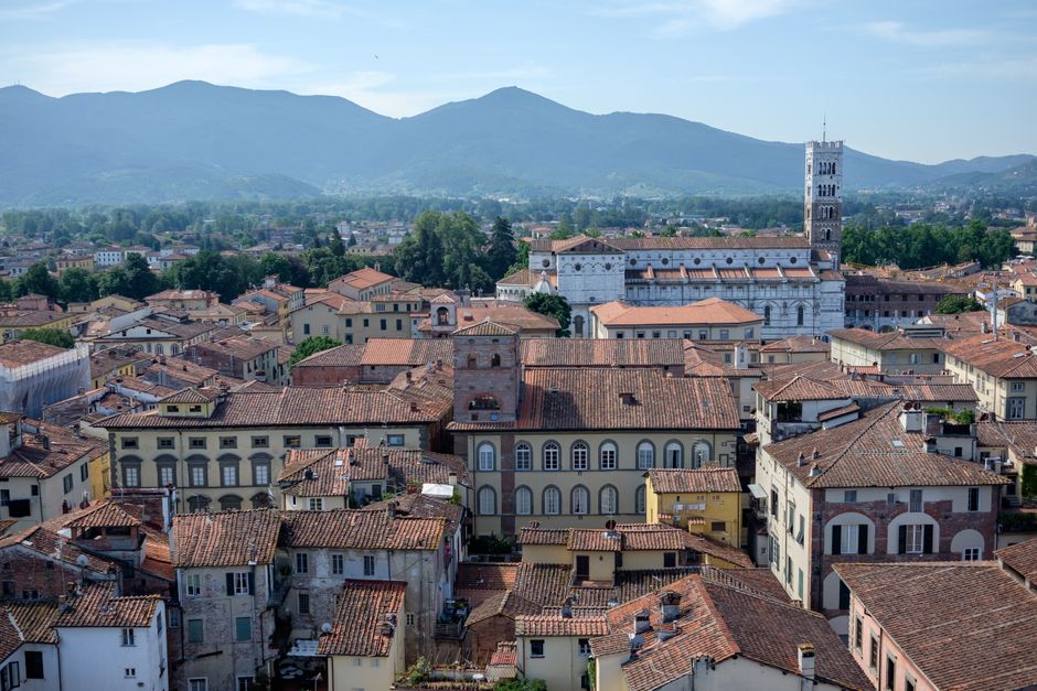 A picturesque aerial view of Lucca, Tuscany, showcasing historical buildings and scenic hills.