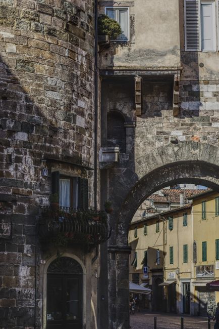 Explore the narrow streets and historic architecture of Lucca, Tuscany.