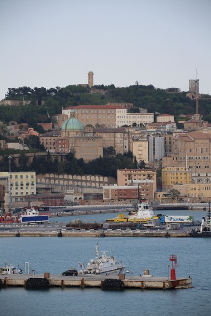 A stunning aerial view of Ancona's historic architecture and bustling port with vibrant boats.