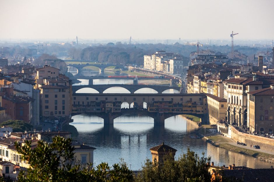 Aerial view of the historic Ponte Vecchio bridge over the Arno River in Florence, Italy.