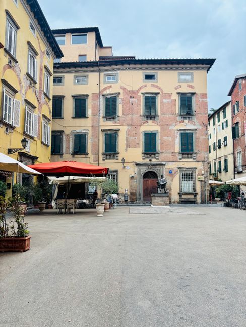 Charming empty piazza with historic buildings in Lucca, Tuscany, Italy.