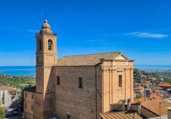 A picturesque view of a historic church near the Adriatic Sea, capturing architectural beauty and coastal landscape.