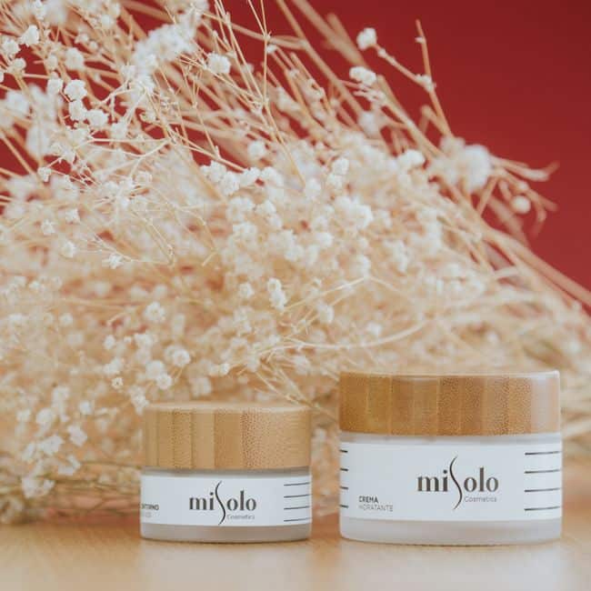 Close-up of beauty products with delicate flowers, evoking natural wellness.