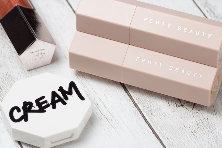 Stylish arrangement featuring beauty products on a wooden background, showcasing elegant packaging.