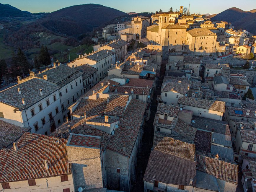Breathtaking aerial view of a traditional Italian town with classic architecture and scenic hills.