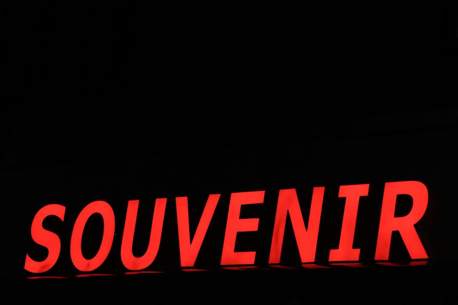 Glowing red souvenir sign in Copenhagen during night time, capturing vibrant urban nightlife.