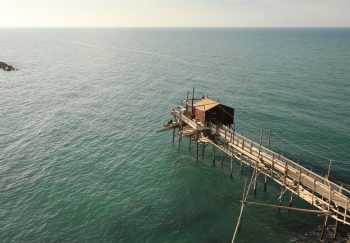 Aerial shot of a traditional Italian Trabocco structure over the Adriatic Sea in Termoli.