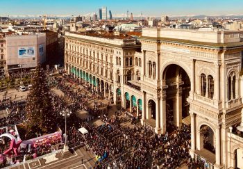 A bustling scene at Galleria Vittorio Emanuele II in Milan during the holiday season.