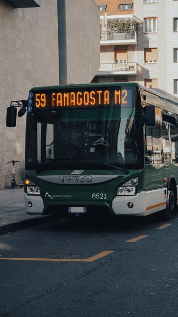 City bus route 59 towards Famagosta M2 in Milan, Italy on urban street.