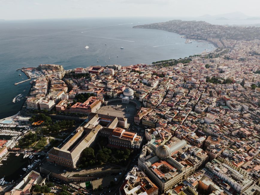 A breathtaking aerial view showcasing Naples, Italy's coastal cityscape and iconic landmarks.