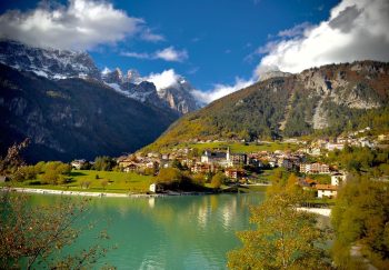Beautiful autumn view of Molveno village and lake with mountains in Trentino, Italy.