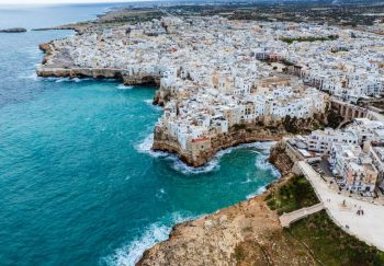 Stunning aerial view of Polignano a Mare, Italy, showcasing its coastal beauty and historic architecture.
