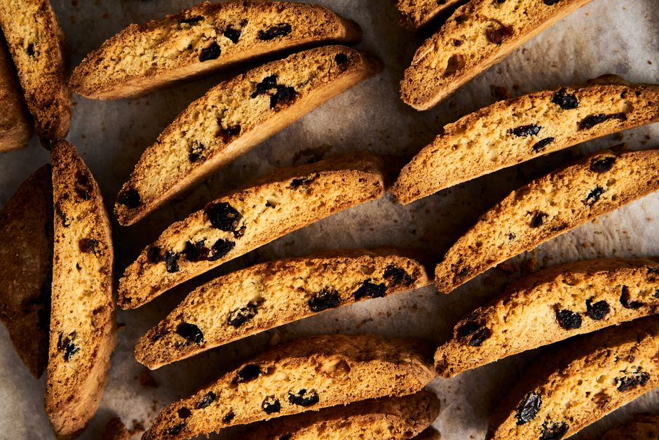 Top view of freshly baked biscotti cookies with raisins on parchment paper.