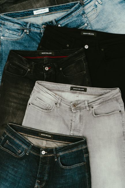 Top view showcasing various denim jeans in different shades and styles.