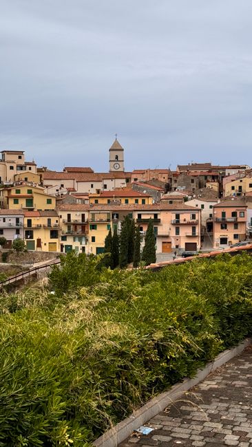 Picturesque village in Tuscany with traditional architecture and a central clock tower.