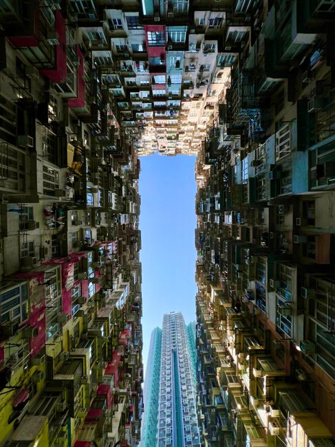 Dynamic contrast of old and new architectural styles in Hong Kong Island's housing structures.