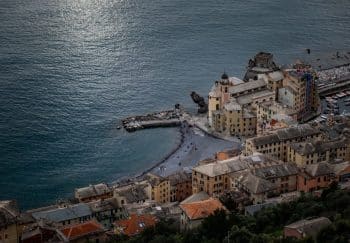 Aerial scene of historic Camogli, Italy, showcasing coastal architecture and serene Mediterranean shoreline.
