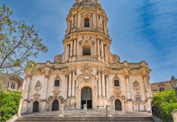 Stunning view of a historic Baroque cathedral in Modica, Sicily with stone stairway.