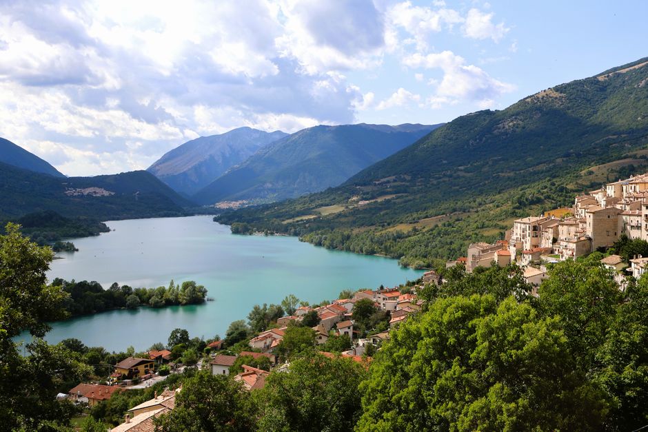 Breathtaking panoramic view of Villetta Barrea with stunning lake and lush mountains in Abruzzo, Italy.