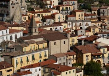 Serene view of a picturesque Italian village with traditional houses and scenic landscape.