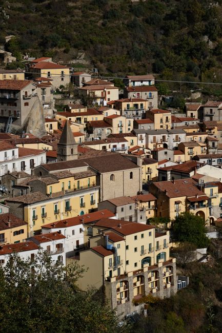 Serene view of a picturesque Italian village with traditional houses and scenic landscape.