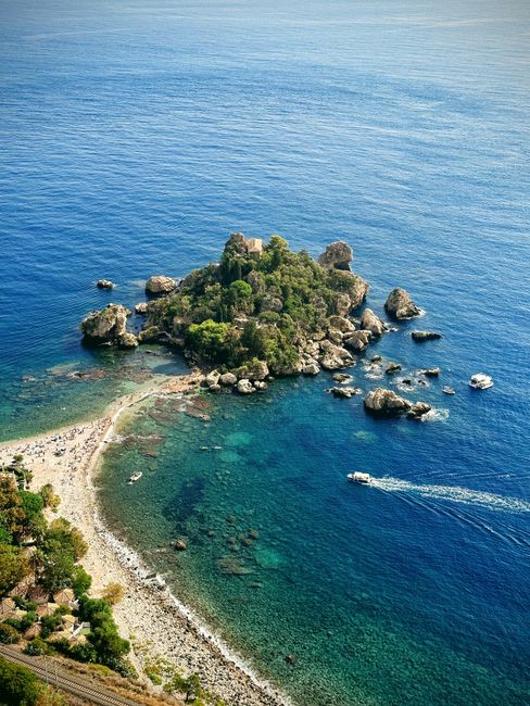 Stunning aerial shot of Isola Bella, showcasing crystal-clear waters and lush greenery, perfect for travel inspiration.