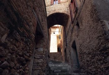 Explore the quaint stone alleyways of an Italian village with rustic charm.