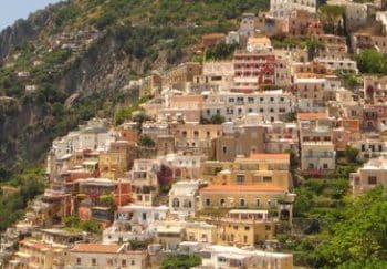 Stunning hillside view of the colorful houses of Positano on the Amalfi Coast under a clear blue sky.