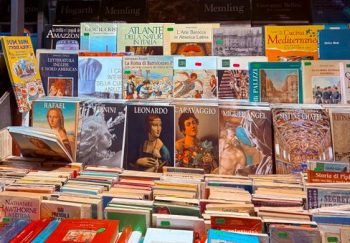 Vibrant art book display at a bookshop in Toscana, Italia, featuring classics and modern art publications.