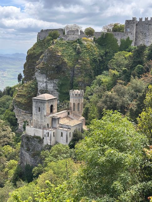 A breathtaking view of the medieval castle in Erice, nestled atop lush cliffs in Sicily.