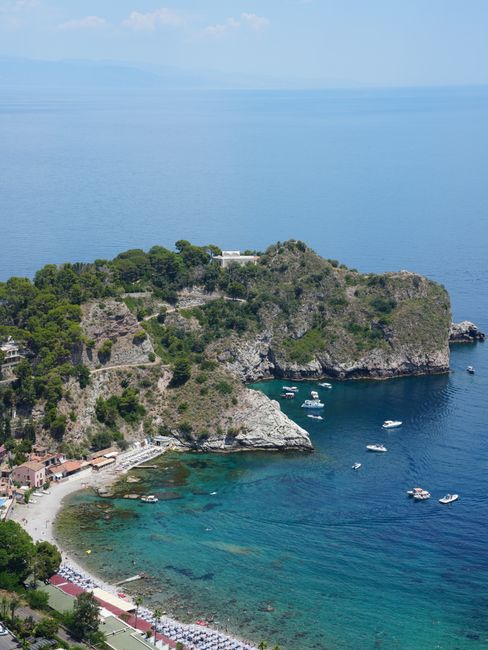 A beautiful aerial shot of Isola Bella, Sicily, showcasing turquoise waters and lush greenery.