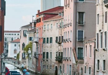 Discover the charm of Venice with this picturesque canal view, featuring colorful historic facades and iconic architecture.