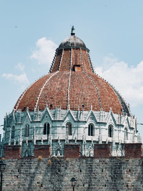 Close-up view of the Florence Baptistery showcasing its iconic dome under a clear blue sky.