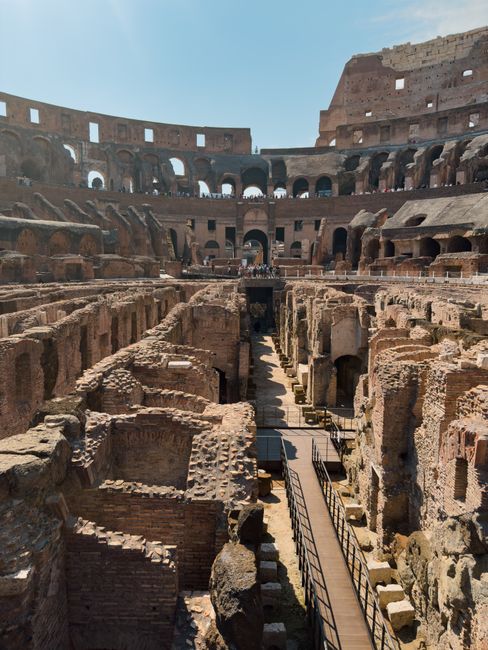 Explore the interior ruins of the historic Roman Colosseum, bathed in sunlight.