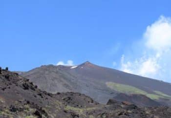 Stunning view of Mount Etna's volcanic terrain under a clear blue sky in Sicily, Italy.