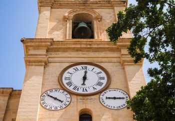 Exterior view of the iconic St. John's Co-Cathedral clock tower in Valletta, Malta.