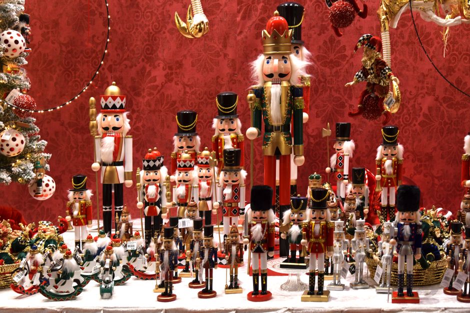 A vibrant display of nutcracker figurines and Christmas decorations in a festive setting.