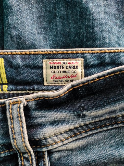 Detailed view of Monte Carlo Clothing Co. label on denim fabric.