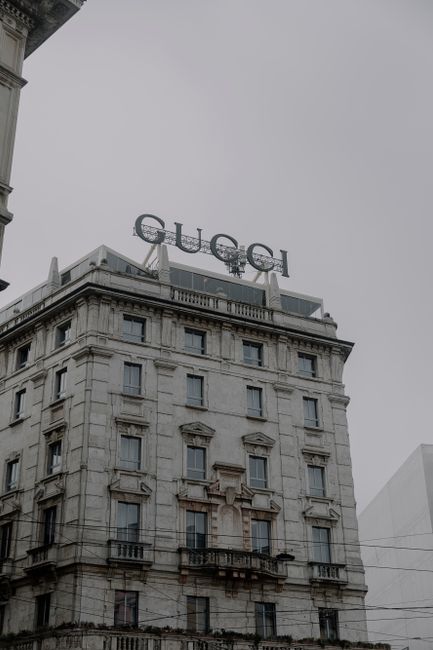 View of the iconic Gucci building facade in Milan, highlighting classic architecture and urban setting.